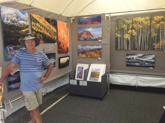 Casey in front of his art festival booth
